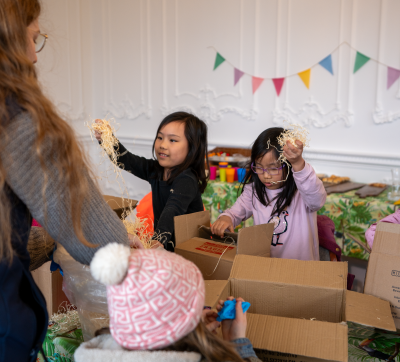 birthday party children putting straw into boxes