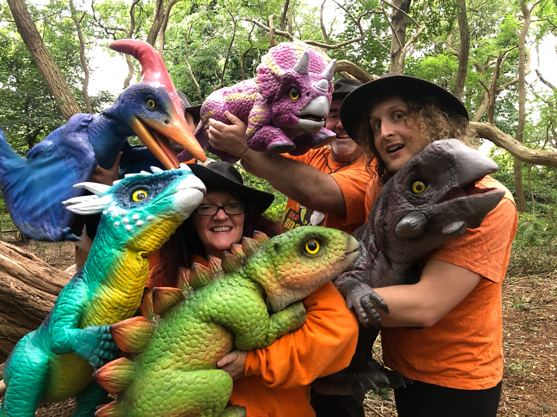 people holding toy dinosaurs