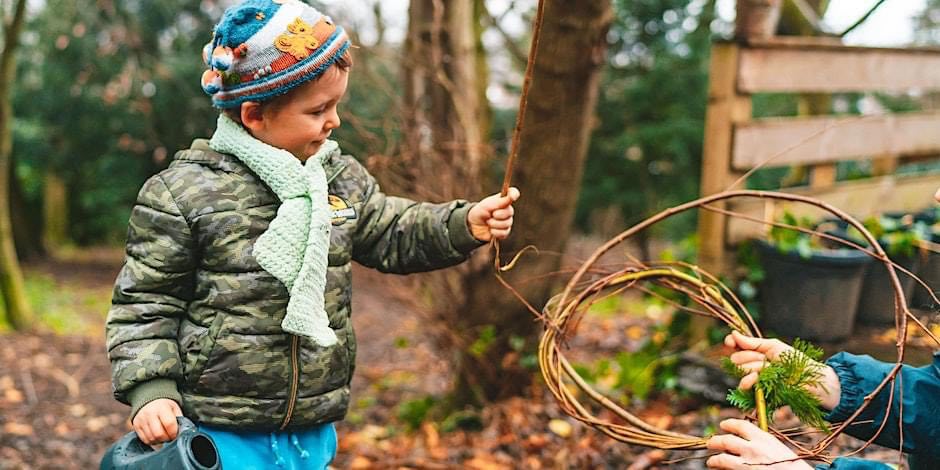 child in woods in hat, scarf and jacket playing with stick edinburgh science festival wild learning