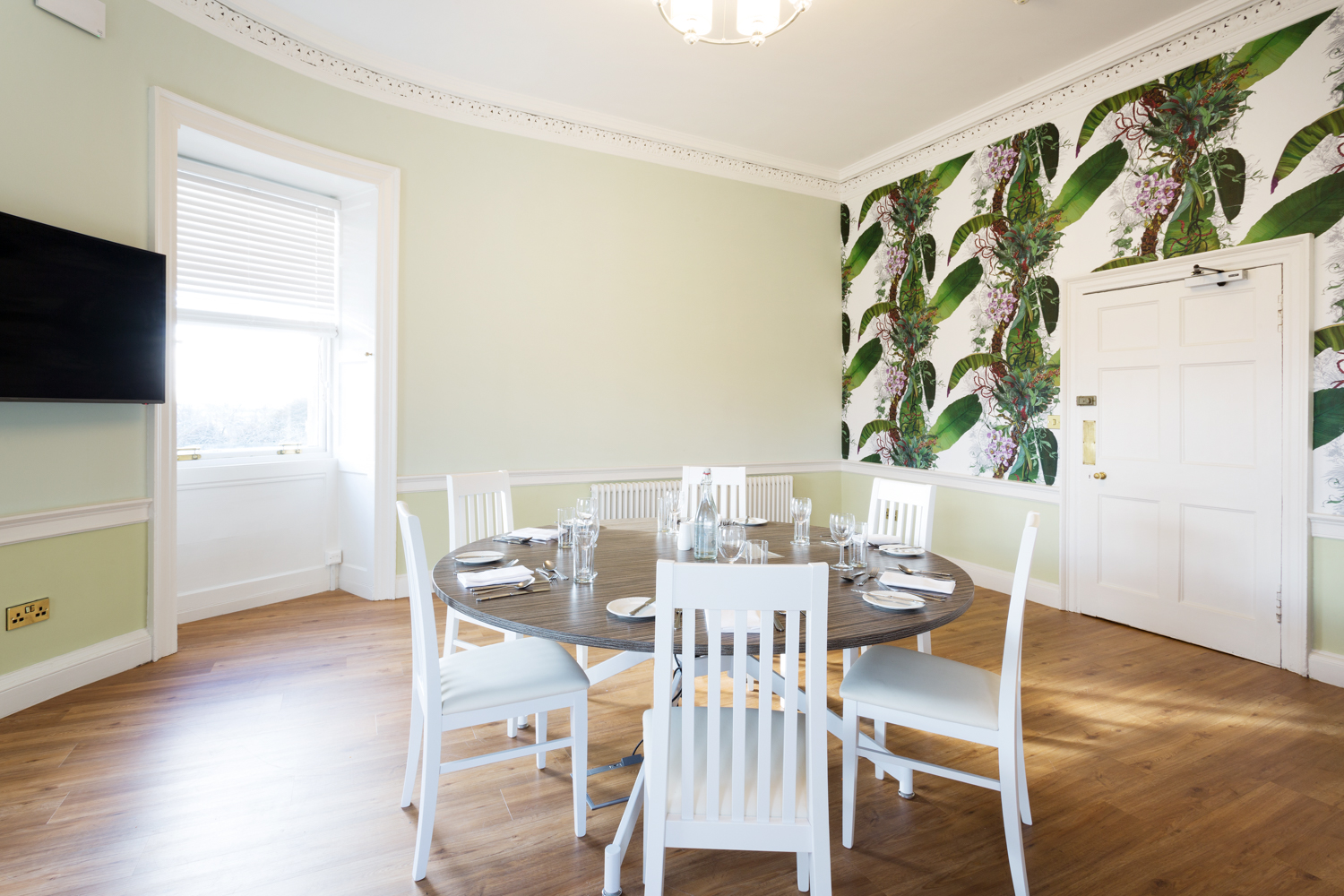 mansion house room with foliage wallpaper in shot and table set up with glassware IMAGE: Blue Sky 2023