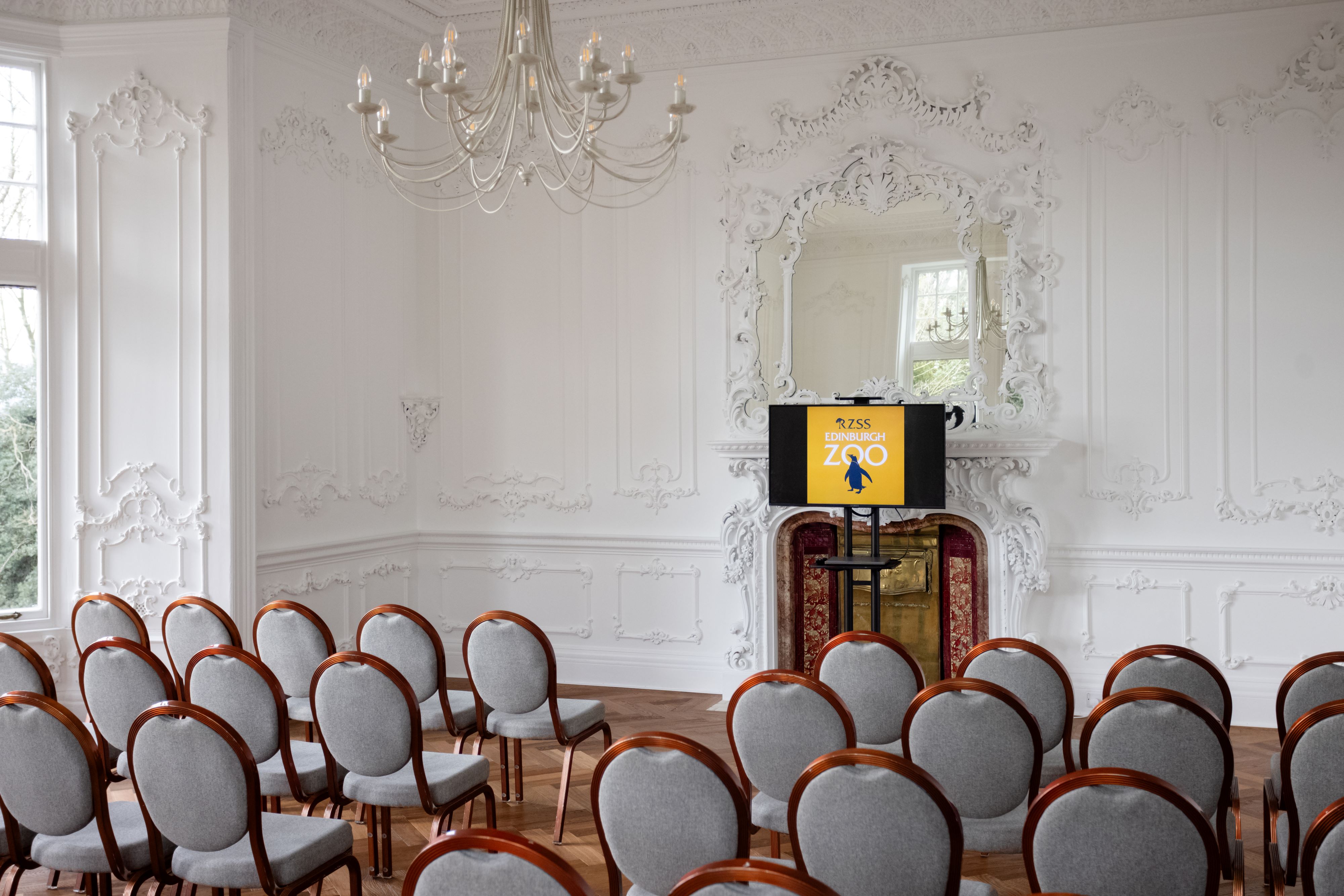 mansion house meeting room with conference chairs pointing at a tv screen with the edinburgh zoo logo IMAGE: Blue Sky Photography 2024
