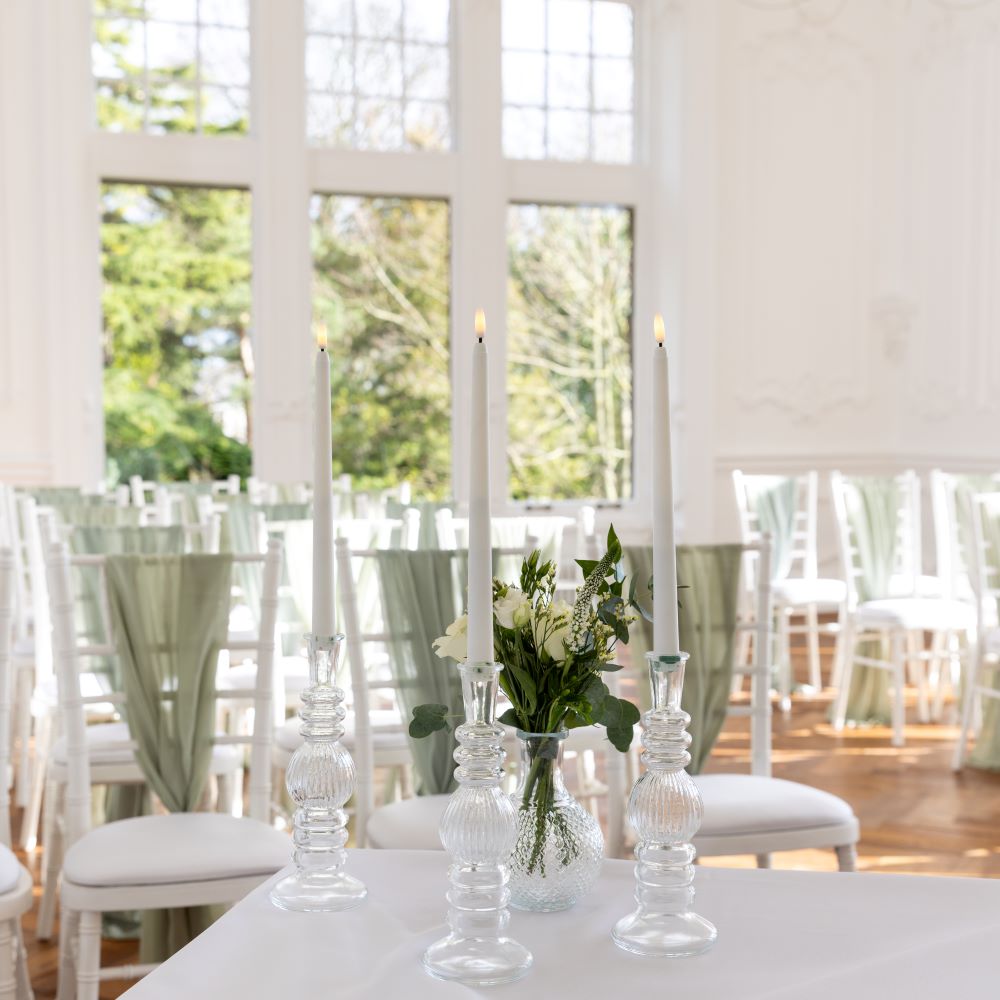 mansion house table decorated for wedding with lit candles and chairs in background IMAGE: Blue Sky Photography 2024