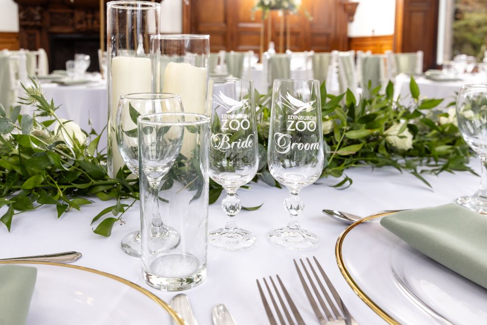 bride and groom glasses on table with centrepiece IMAGE: Blue Sky Photography 2024