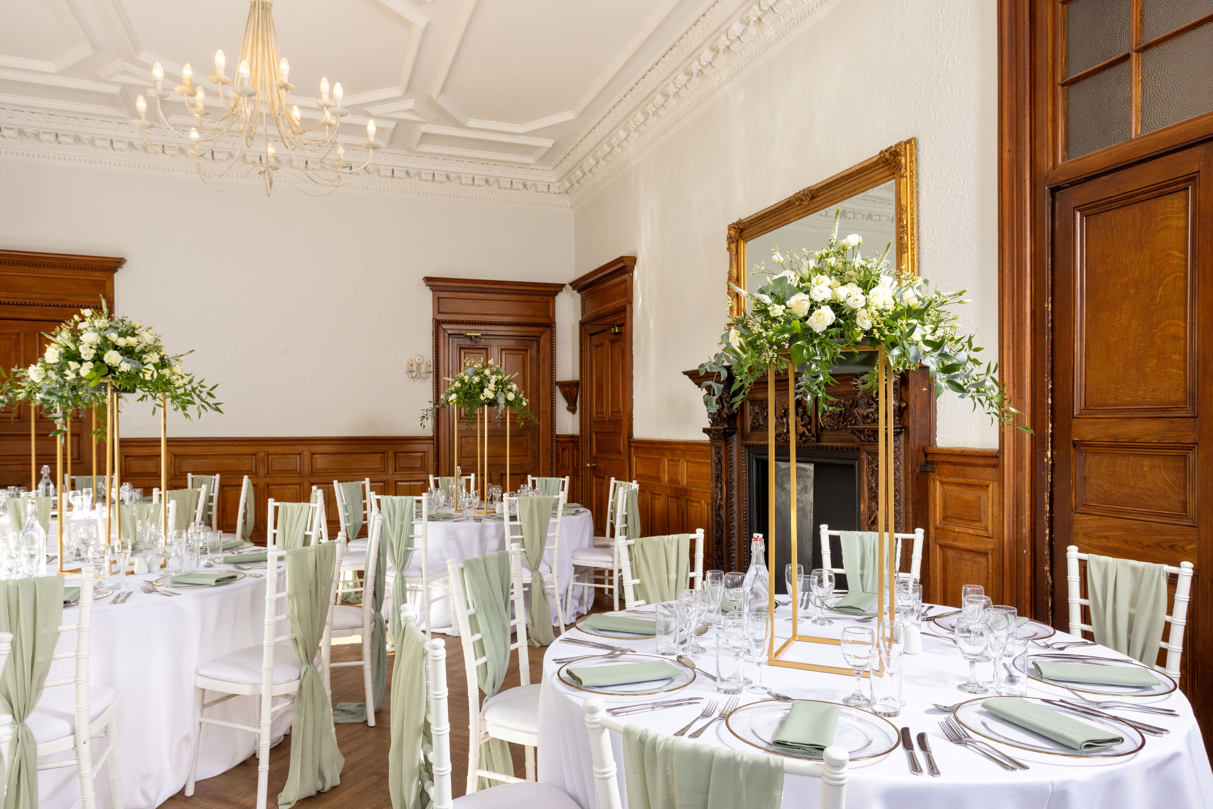 mansion house wedding room with floral centrepieces and table and chairs IMAGE: Blue Sky Photography 2024