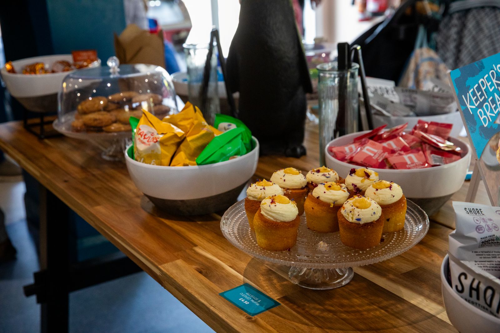 A selection of baked goods and crisps shown on a sideboard in the Penguins Cafe at Edinburgh Zoo CEDIT RZSS