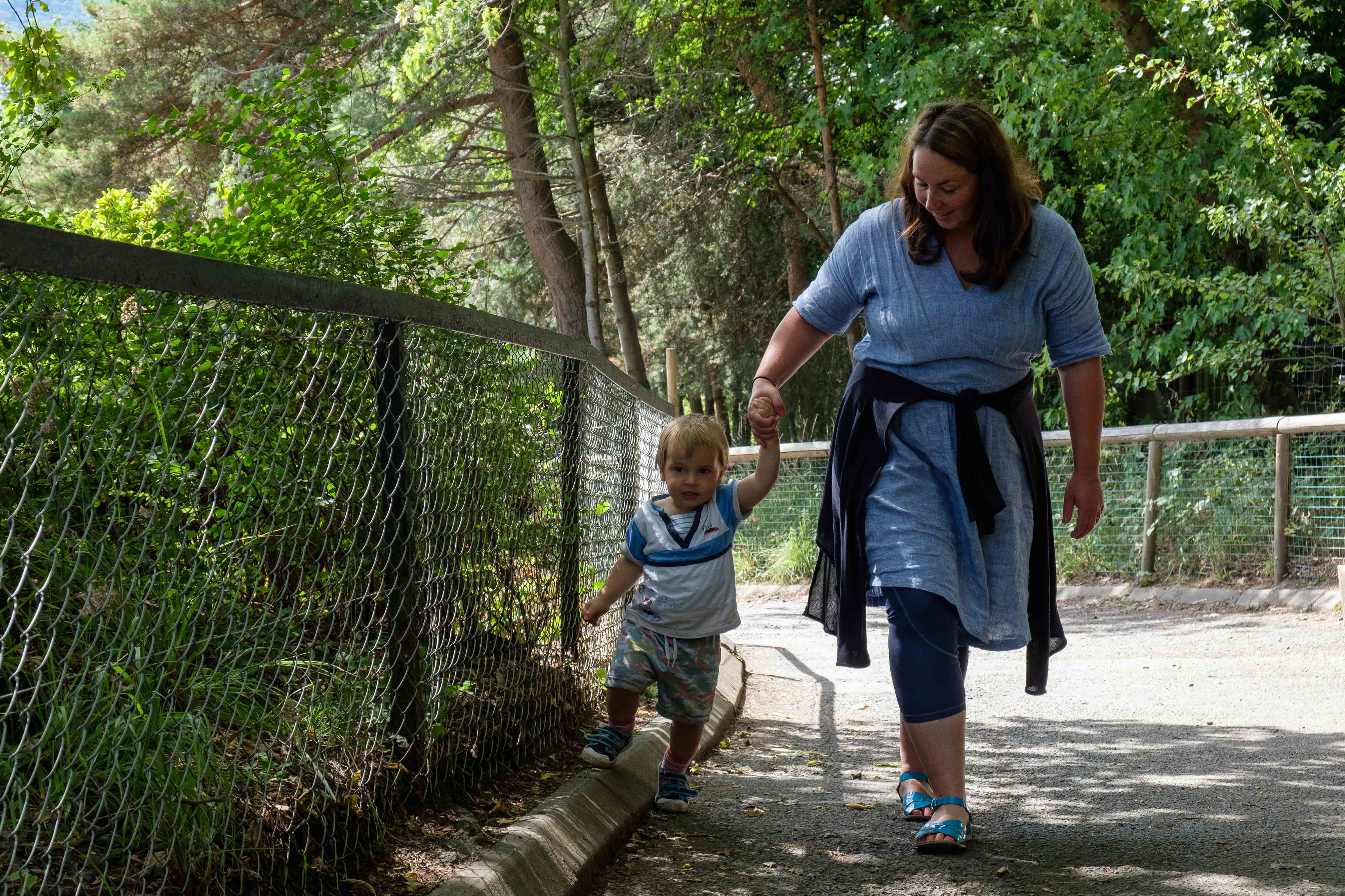 Mother and child walking up to tiger tracks holding hands IMAGE: Robin Mair 2022