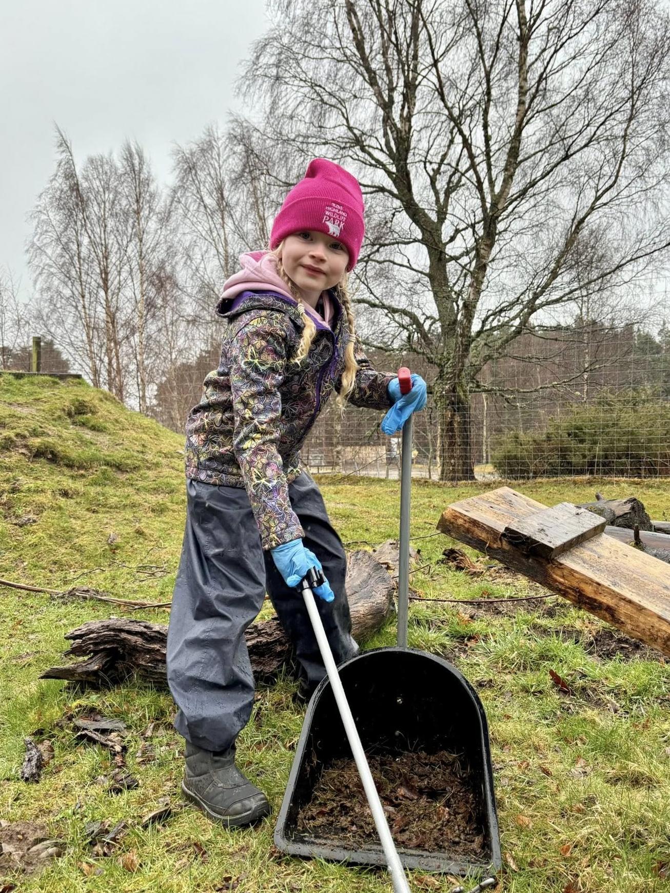 two children walking holding buckets and smiling to the side IMAGE: Rachel Hein 2024