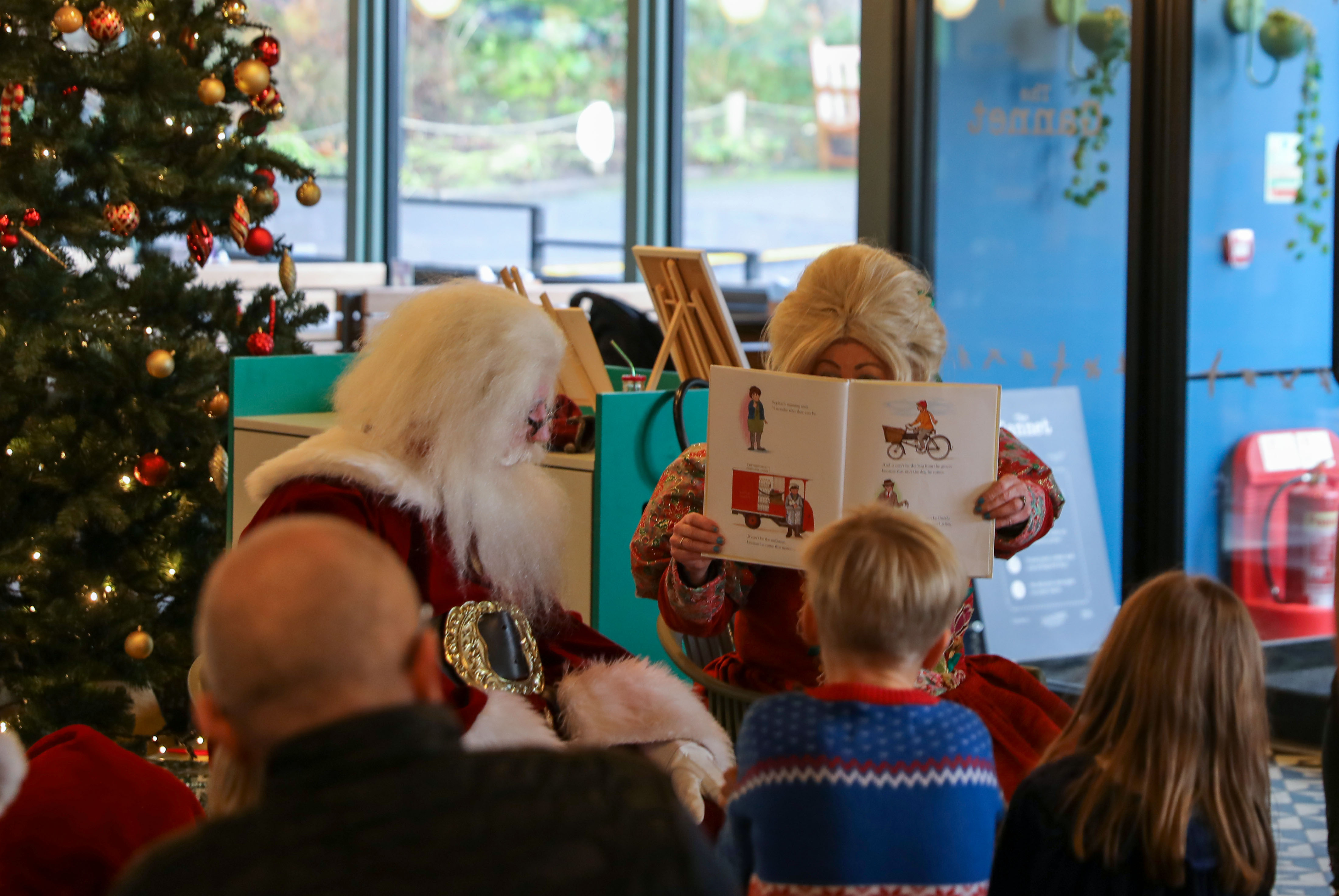 mrs claus reading a book to a group of children in the gannet restaurant IMAGE: RZSS