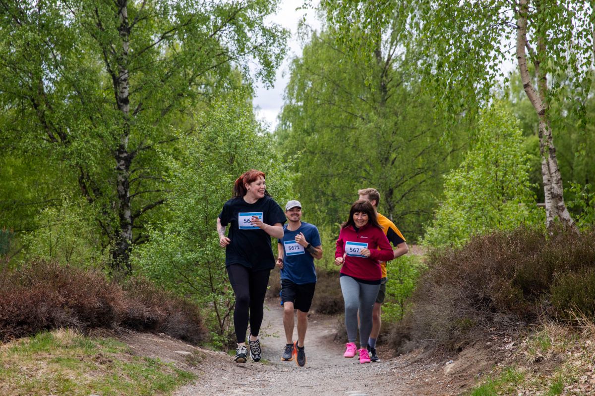 A group of runners jogging along a path at Highland Wildlife Park wearing running numbers. IMAGE: Olivia Torley May 2026