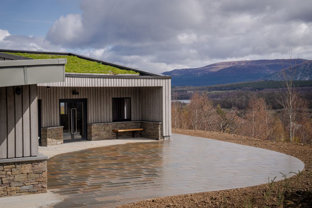 exterior shot of learning hive with grass on roof and hills in background IMAGE:RZSS 2024