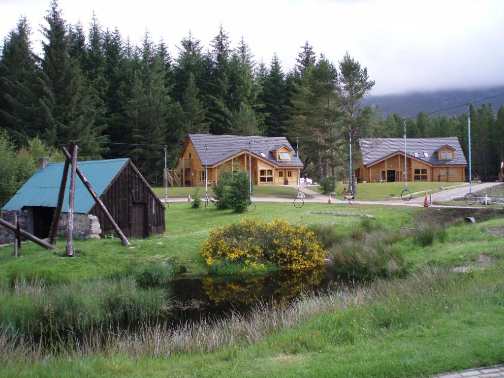 badaguish outdoor centre with lodges and forest in background