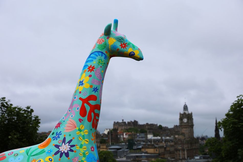 Giraffe about town statue on Calton hill with cityscape behind

Image: 2021