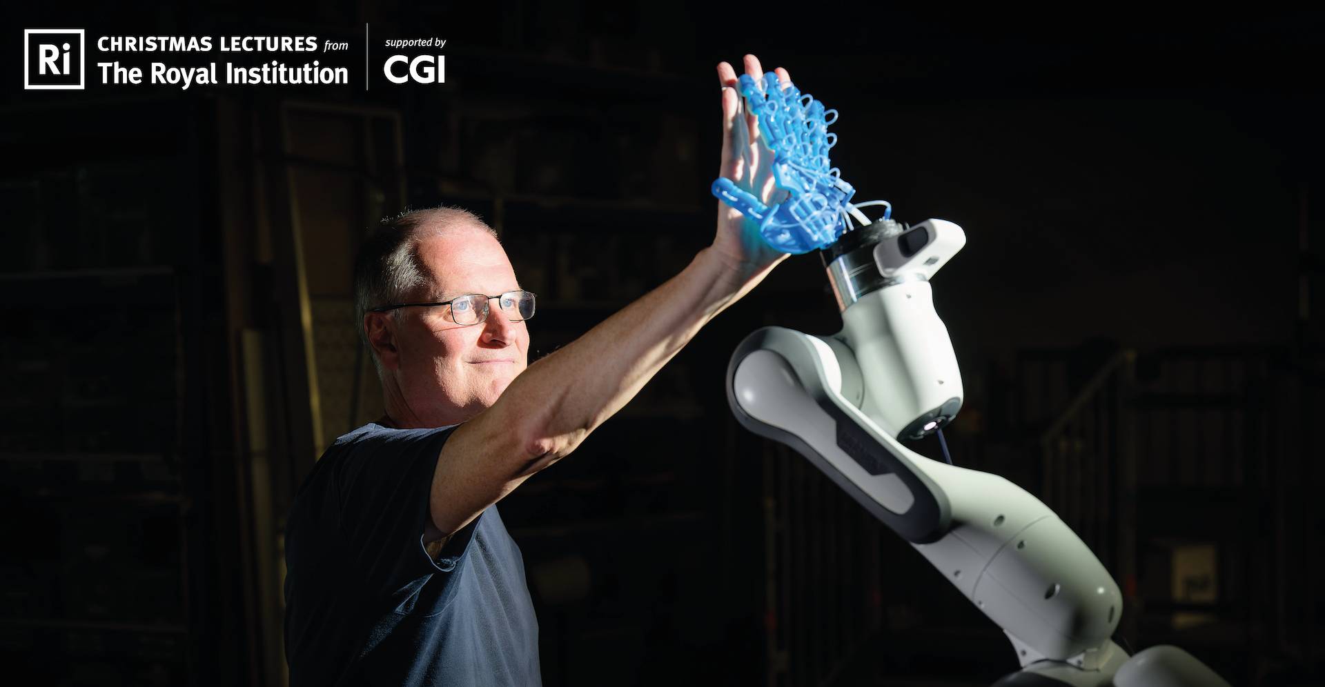 Promotional image for Royal Institute Christmas lectures showing man reaching to robot arm