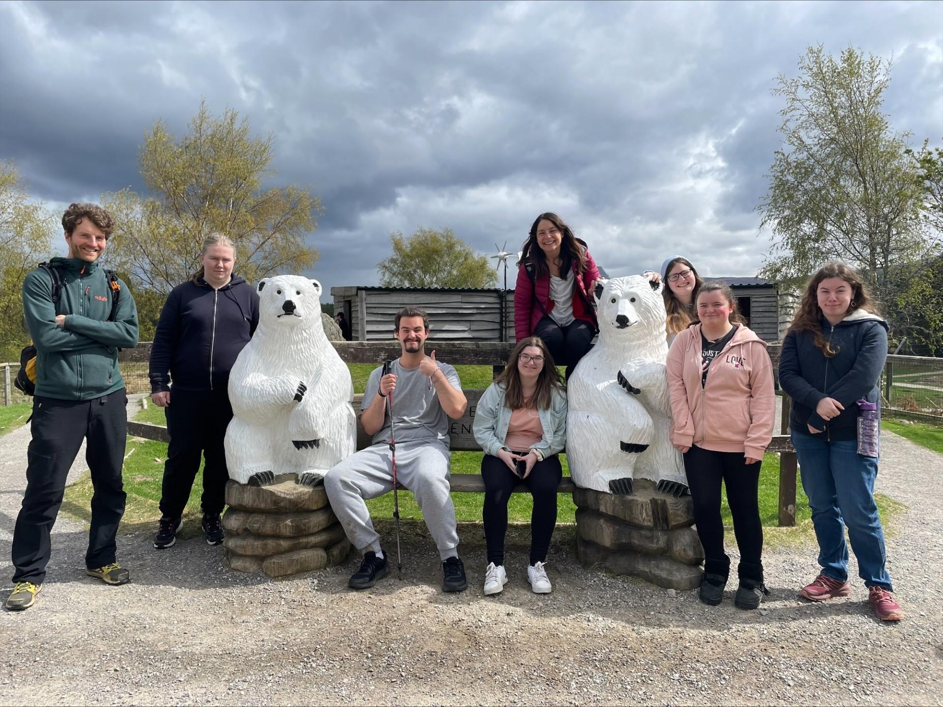 UHI Perth students pose for photo by small polar bear statues during visit to Highland Wildlife Park