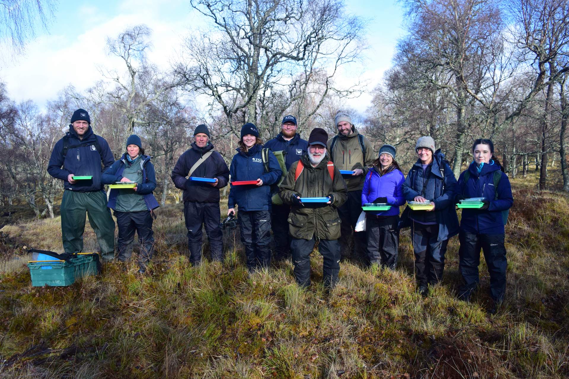 RZSS staff and Rare Invertebrates in the Cairngorms partners pose in group together with trays for dark bordered beauty moth egg releases

Image: RZSS CONSERVATION 2024